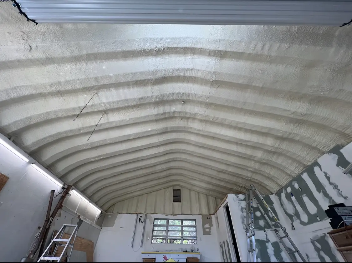 Spray polyurethane foam applied to the underside of a metal roof deck in Forrest City